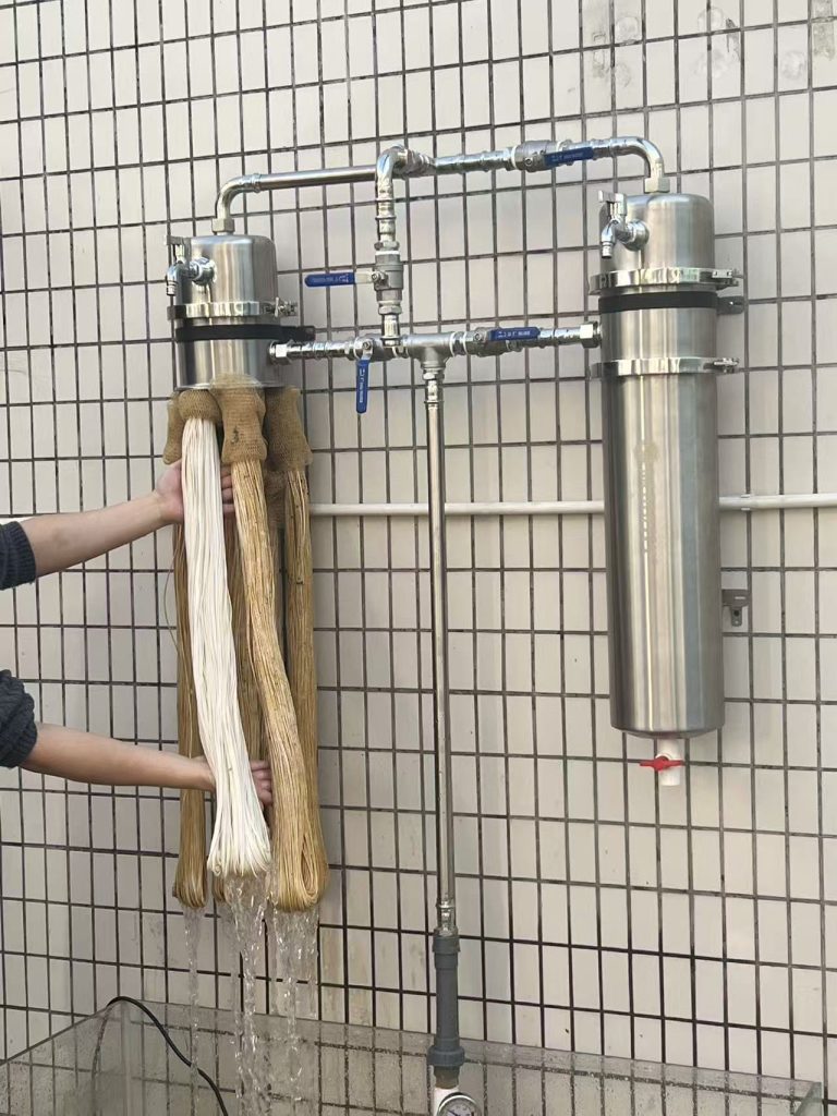 Actual photo of a ChengrongTimes PVDF ultrafiltration membrane cartridge being manually washed while clean water is simultaneously backflushed through the membrane.